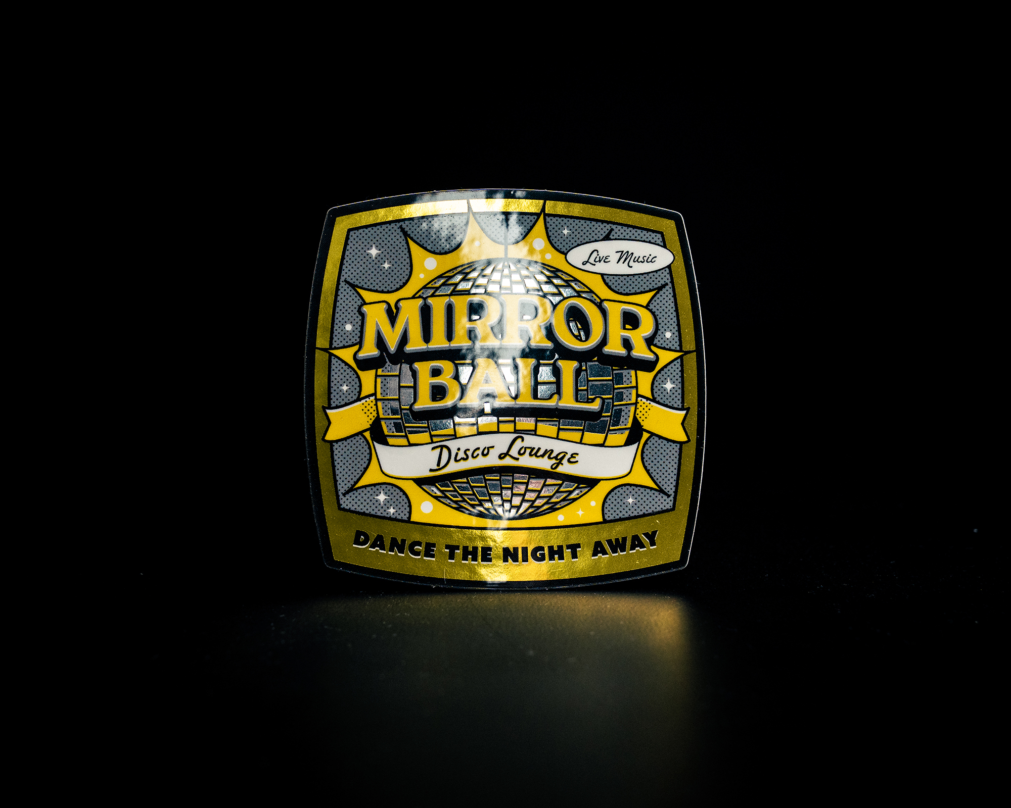 Yellow and black "Mirror Ball Disco Lounge" sticker with a disco ball design and "Dance the Night Away" text on a dark background.